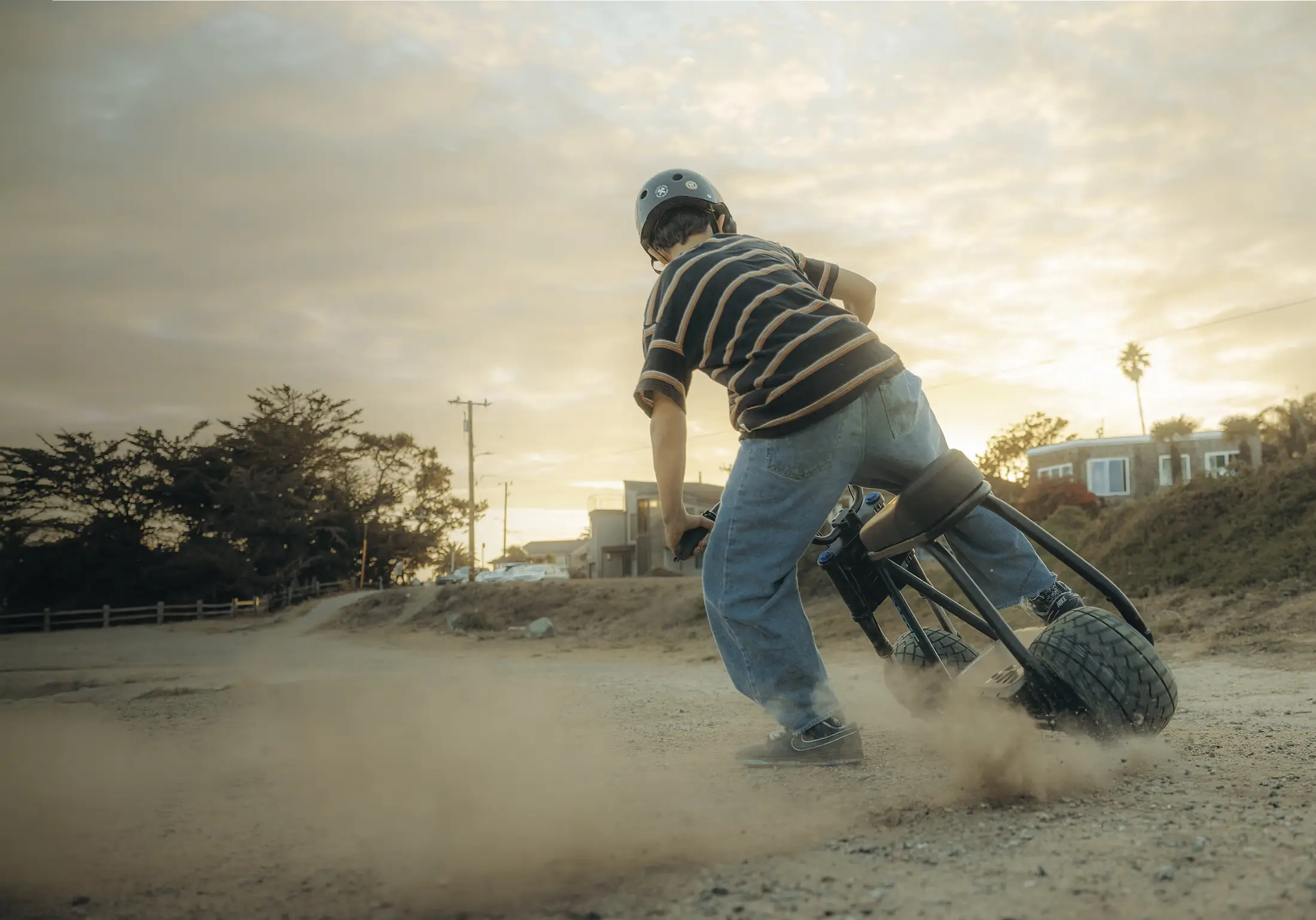 BiikeGo rider kicking up dust on a dirt road